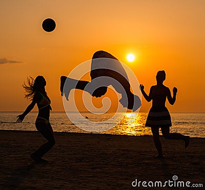 Silhouettes of a people having fun on a beach