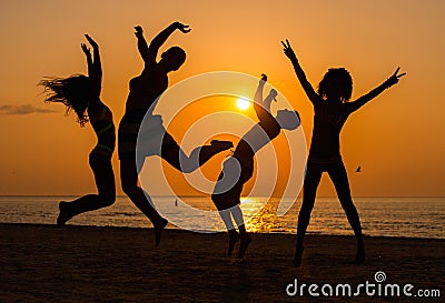 Silhouettes a young people having fun on a beach