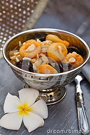 Silver bowl with dried fruits and nuts dessert