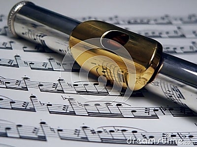 Silver and Gold Flute over sheet music