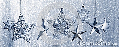Silver Stars Hanging against Glitter Background