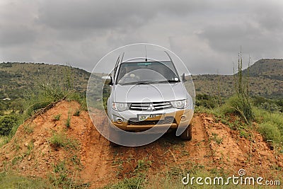 Silver Toyota Triton DHD crossing obstacle