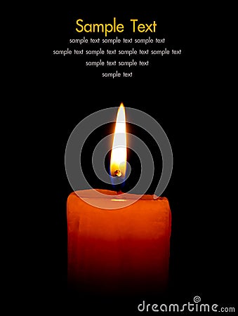 A single burning candle isolated on black