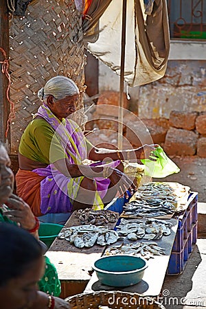 SIOLIM, GOA, INDIA - CIRCA DECEMBER 2013: An elderly woman sells