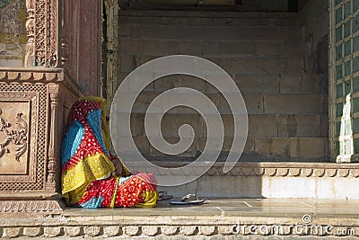 Sitting indian woman in colorful sari