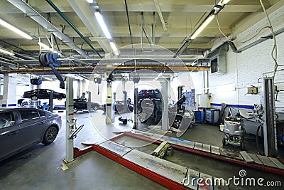 Six black cars stand in garage with special equipment