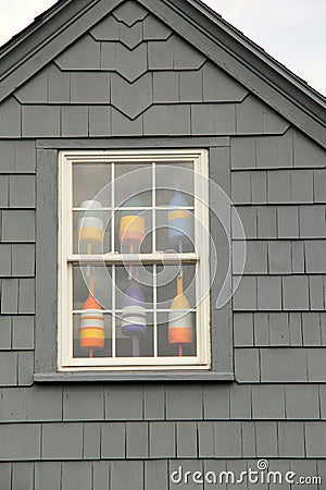 Six colorful nautical buoys in upstairs window