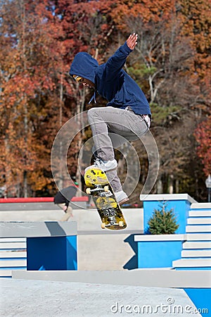 Skateboarder Catches Air At Skateboard Park