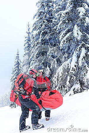 Ski patrol carry injured person in stretcher