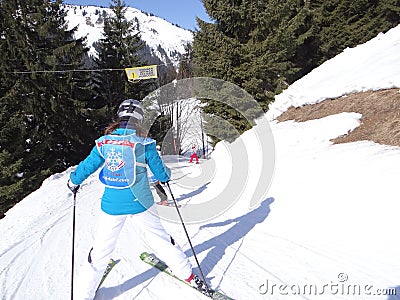 Ski school kids maneuver on an icy road