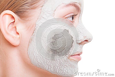 Skin care. Woman applying clay mask on face. Spa.