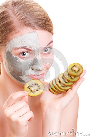 Skin care. Woman applying clay mask on face. Spa.