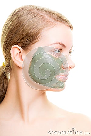 Skin care. Woman with clay mud mask on face.