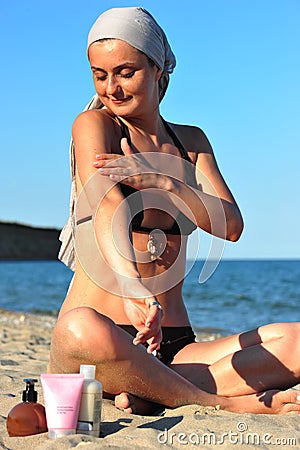 Skin health: woman applying sun block