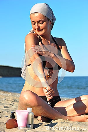 Skin health: woman applying sun block