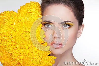 Skincare. Attractive young woman with flowers. Cleansing and moi
