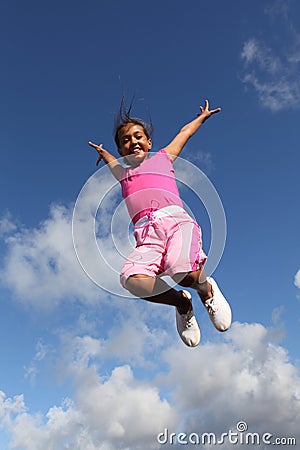 Sky is the limit jump for joy by young school girl