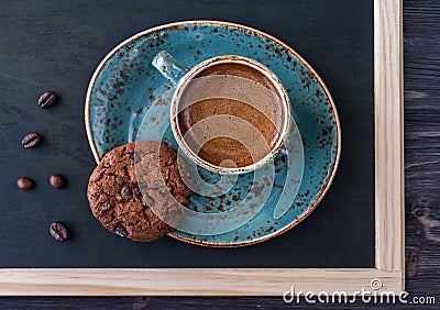 Slate chalk board with a cup of coffee and chocolate chip cookies. Vintage style