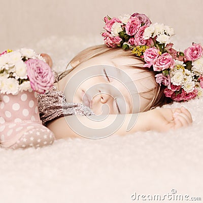 Sleeping baby girl in flowers, beautiful vintage background