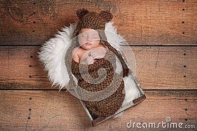 Sleeping Newborn Baby Boy Wearing a Bear Hat