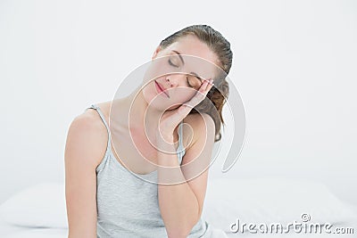 Sleepy woman sitting in bed