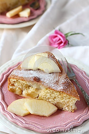 Slice of homemade apple sponge cake on pink plate