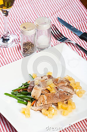 Sliced pork steak with french beans and apple diced sauce