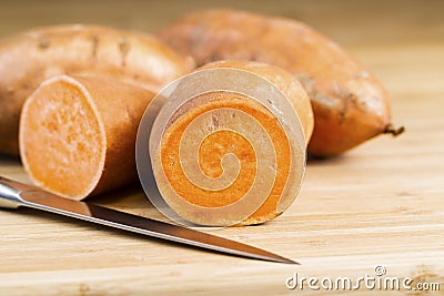 Stock Images: Sliced Yam on natural bamboo cutting board with Knife