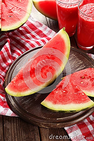 Slices of watermelon on brown wooden background