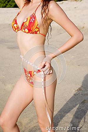 Slim body figure woman measuring waist line
