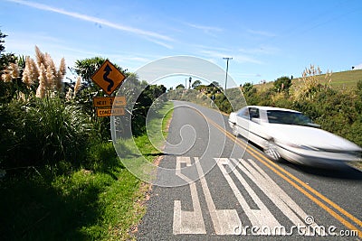 Slow marking on the road and fast car