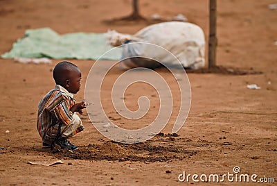 Small african boy squatting