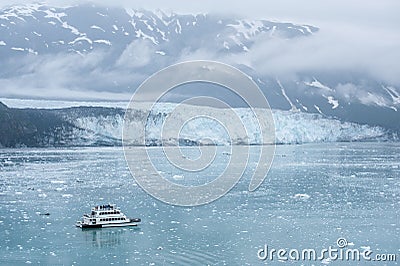 Small boat with tourists watching Hubbard Glacier. Alaska