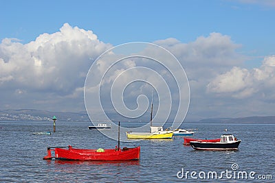 Small boats in Morecambe Bay at high tide.