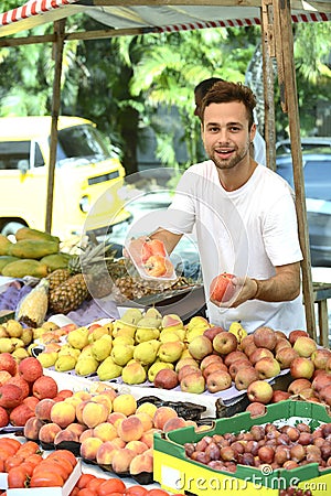 Small business owner selling organic fruits.