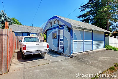 Small garage with truck and fence