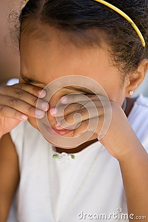 Small girl child rubbing eyes