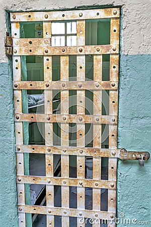 Small jail cell with a bed in it