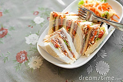 Small pieces Tuna Salad Sandwiches on table