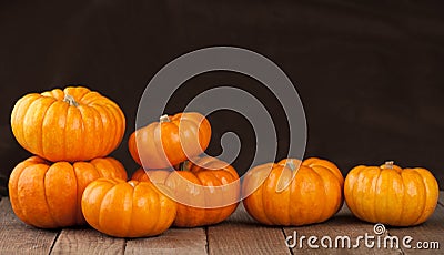 Small Pumpkins on Rustic Wooden Boards