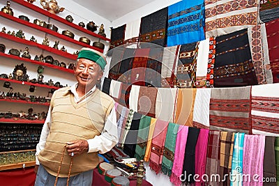 Small shop owner indian man at his souvenir store