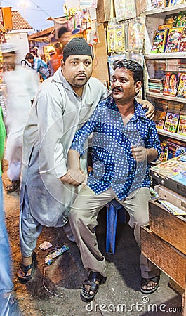 Small shop owner indian man selling