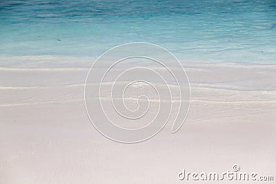 Small wave roll into white sand beach