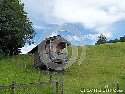 Small wooden alpine style house on the hill