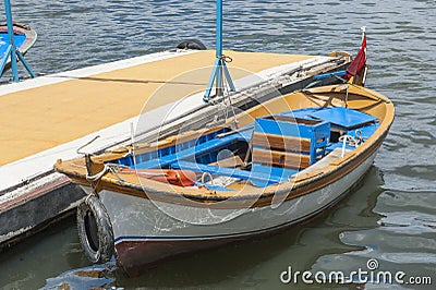 Small wooden motor boat moored up