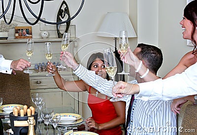Smartly dressed people at a dinner party with Champagne