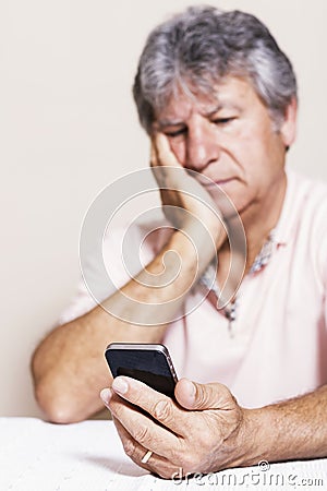 Smartphone and senior man at home