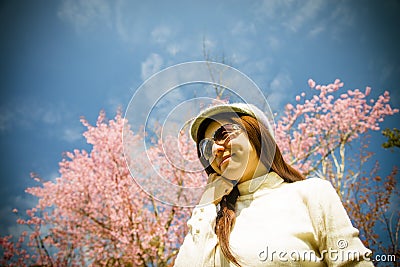 Smile lady with pink cherry flower and blue sky