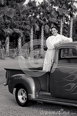 Smiling 1950s teen girl in pickup truck