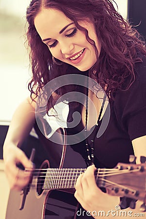 Smiling acoustic guitar player